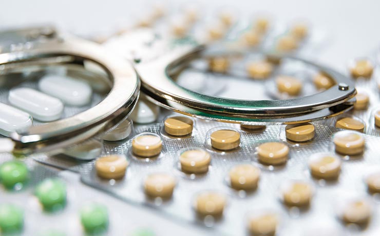 Handcuffs on top of pill packets