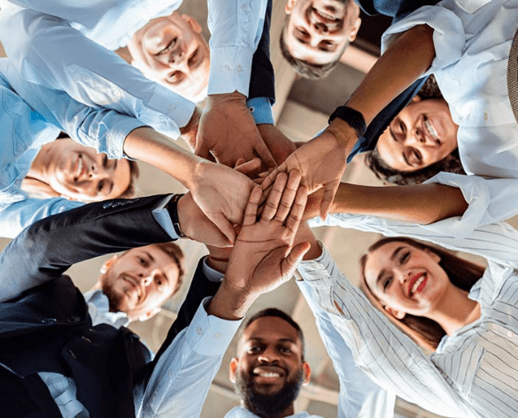 Group of employees putting their hands together in a circle