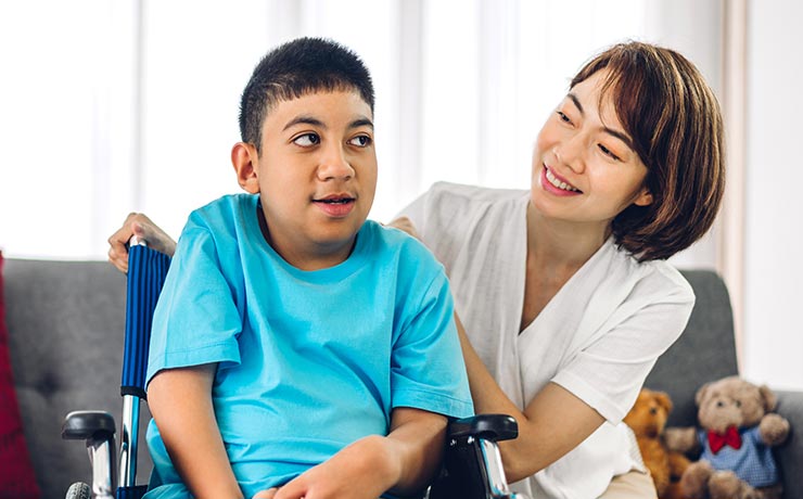 Nurse and disabled child in common area of the facility