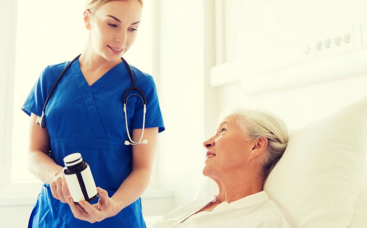 Nurse giving patient his daily medication