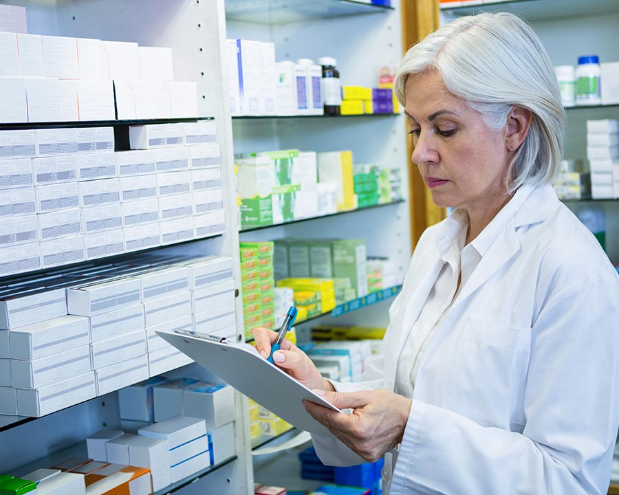 Pharmacist checking medicine quantities
